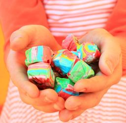 Photo of child holding candy by D Sharon Pruitt; see https://commons.wikimedia.org/wiki/File:Free_Child_Holding_Happy_Colorful_Rainbow_Taffy_Candy_(unedited)_Creative_Commons_(3354087435).jpg